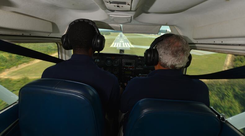 October 3, 2013 Atlanta: Julius Alexander, founder of Aviation Career Enrichment (ACE) coaches student Cayman Howard, 19, in for a landing Thursday October 3, 2013. ACE begin in 1980 as a way to introduce disadvantaged, at-risk and minority youth to aviation opportunities. To date Alexander has instructed 171 students to their first solo flight. BRANT SANDERLIN /BSANDERLIN@AJC.COM