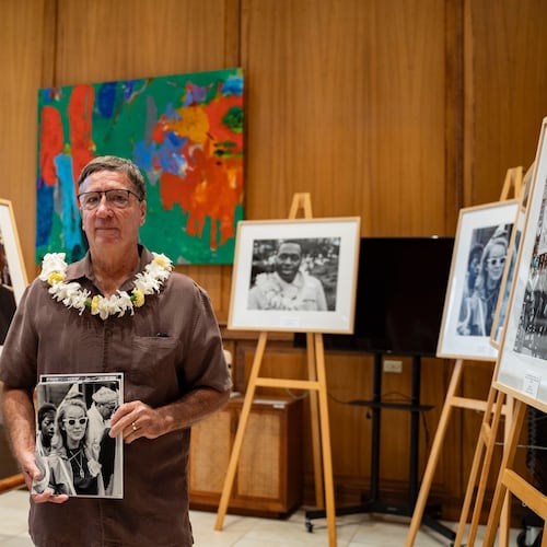 Steven Springel holds a photograph of his mother, Nona Springel Ferdon, a member of Hawaii's delegation to the 1965 Selma-to-Montgomery march, during the opening of a Martin Luther King Jr. photo exhibit at the Hawaii State Capitol, Tuesday, June 30, 2026, in Honolulu. (AP Photo/Mengshin Lin)