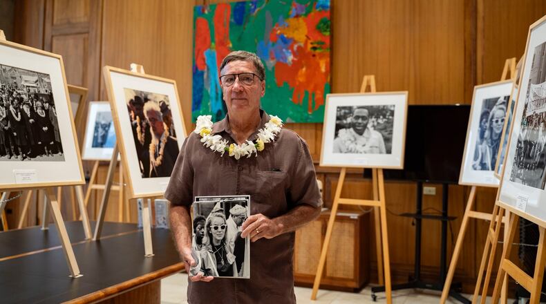 Steven Springel holds a photograph of his mother, Nona Springel Ferdon, a member of Hawaii's delegation to the 1965 Selma-to-Montgomery march, during the opening of a Martin Luther King Jr. photo exhibit at the Hawaii State Capitol, Tuesday, June 30, 2026, in Honolulu. (AP Photo/Mengshin Lin)