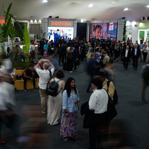 People walk outside the Indonesia Pavilion at the COP30 U.N. Climate Summit, Monday, Nov. 10, 2025, in Belem, Brazil. (AP Photo/Fernando Llano)