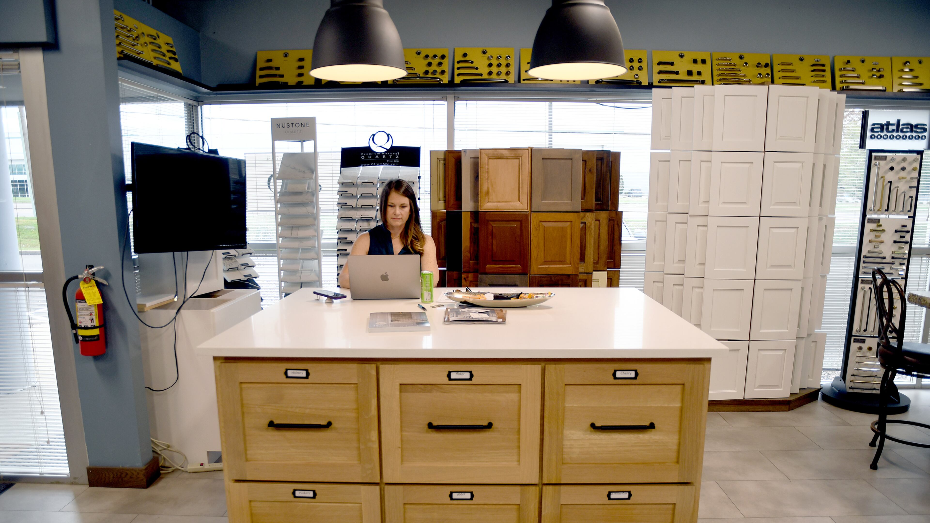 Andrea Mulkey, president and founder of Amish Cabinets of Denver, works in her showroom in Denver on Friday, Oct. 10, 2025. (AP Photo/Thomas Peipert)