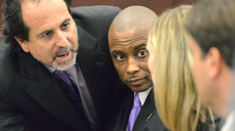 Clayton County Sheriff Victor (second from left) confers with his defense attorneys (from left) Drew Findling, Marissa Goldberg, and Steven Frey before the announcement of the verdict at Clayton County Superior Court on Aug. 15, 2013. Victor Hill was cleared on all counts in his racketeering trial.
