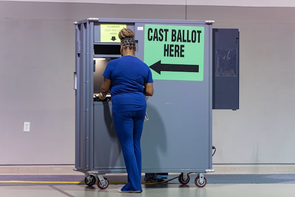 A woman casts her ballot at Austell's Calvary Baptist Church polling location in May. (Ben Hendren for the AJC)