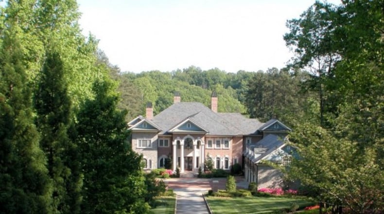 This 13-acre Hall County estate includes a guest house, tennis courts, four-car garage with an apartment and two docks.