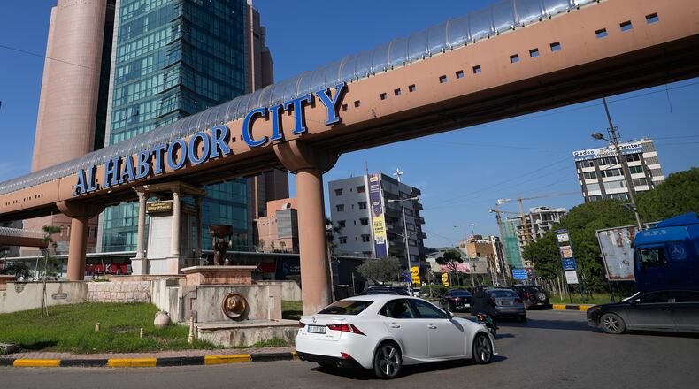 Cars pass next to Habtoor hotel, left, in Beirut, Lebanon, Monday, Jan. 26, 2026. (AP Photo/Hassan Ammar)