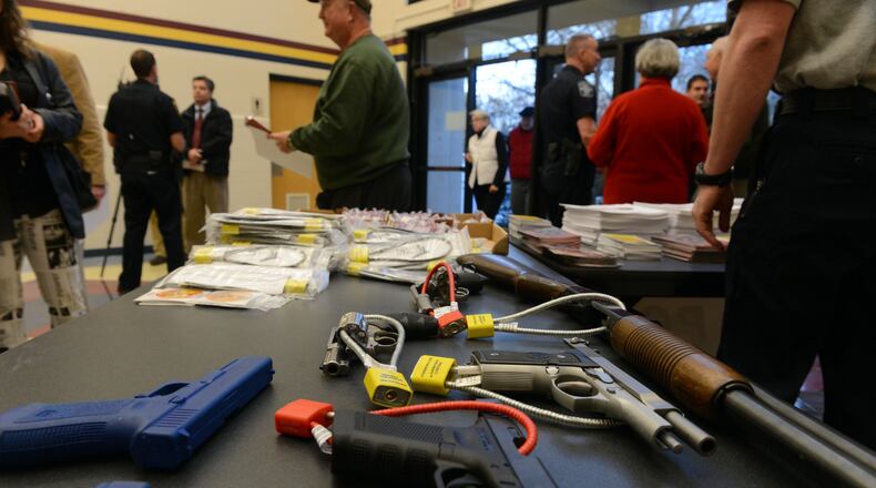 Guns with safety locks are on display at Marietta Police Department's gun safety course, Thursday Jan. 24, 2013.