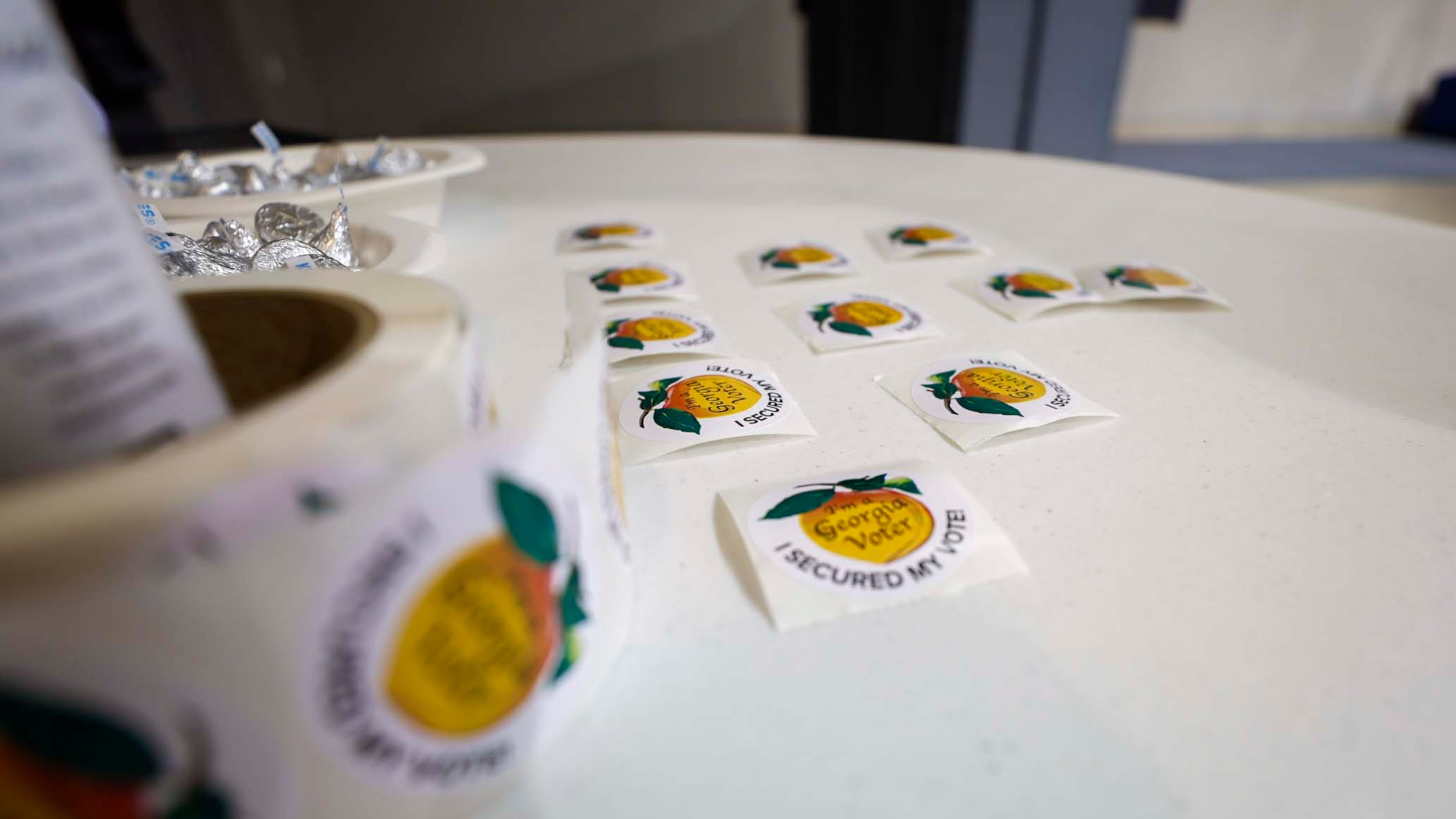 Voting stickers are placed and ready to be handed out at Calvary Baptist Church in Austell during the special election in June. (Miguel Martinez/AJC)