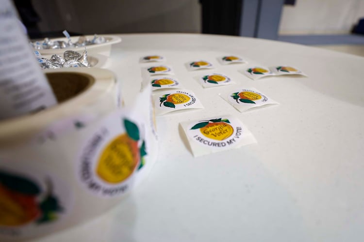 Voting stickers are placed and ready to be handed out at Calvary Baptist Church in Austell during the special election in June. (Miguel Martinez/AJC)