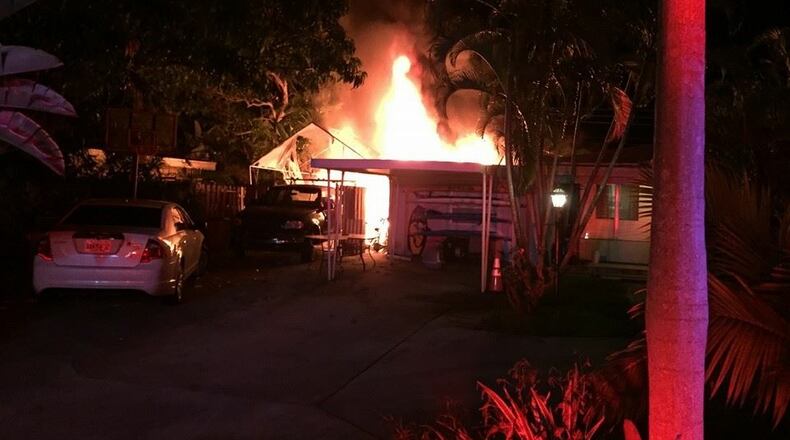Firefighters save a pig from the backyard of a home that caught fire Monday night. There were no reports of injuries. (Photo by Tequesta Fire Rescue)