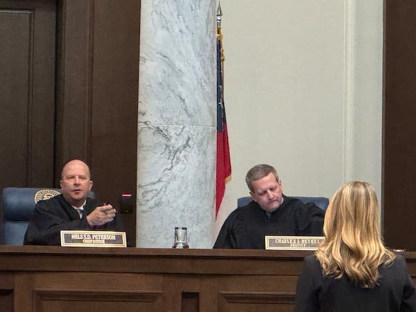 Georgia Supreme Court Chief Justice Nels S. D. Peterson (left) asked an attorney a question during an August hearing in Atlanta.