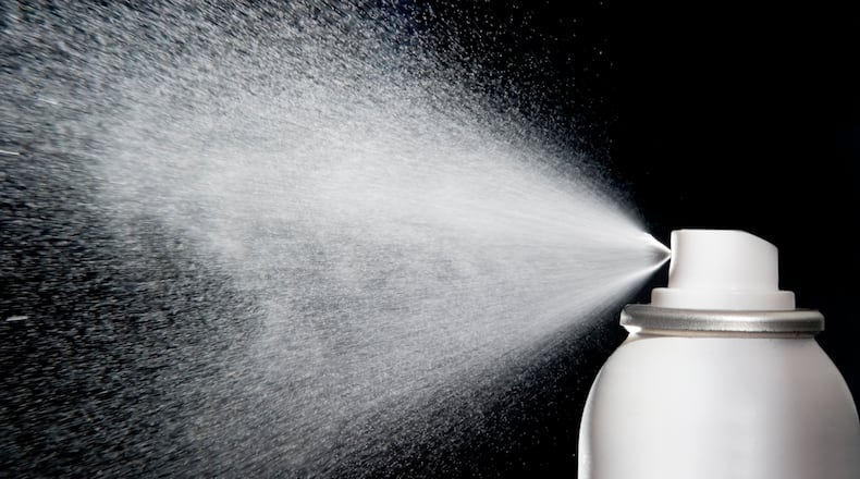 spray aerosol on blacg background