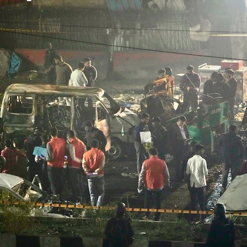Security officers inspect the scene of a car explosion near the historic Red Fort in New Delhi, India, Monday, Nov. 10, 2025. (AP Photo/Manish Swarup)
