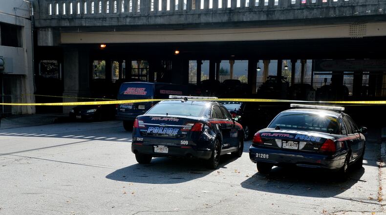 Atlanta police investigate a suspicious death in a parking garage adjacent to the Georgia State campus Friday, November 14, 2014. KENT D. JOHNSON/KDJOHNSON@AJC.COM