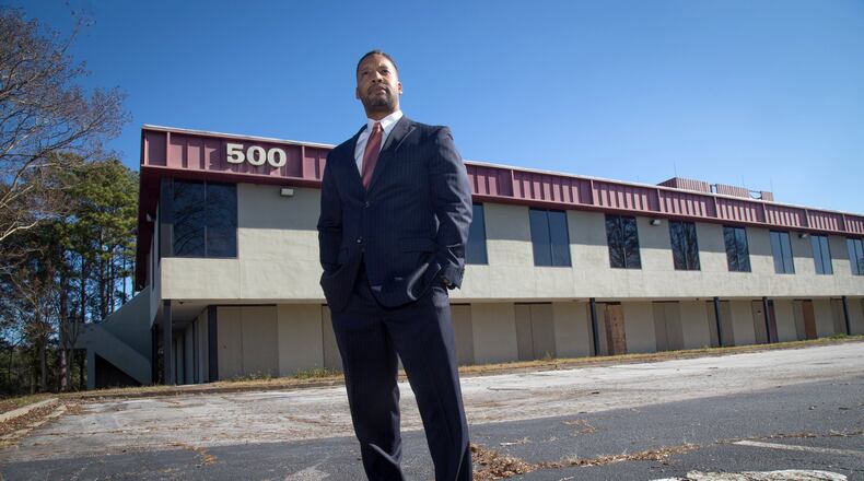 Joshua Butler stands in front of a building he owned before the Great Recession near Fulton County Airport. He says losses totaled $250,000. Monday, Nov. 24, 2018.