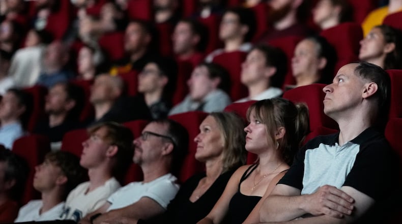 Spectators view the 70 mm Imax copy of Christopher Nolan's "The Odyssey" in Prague, Czech Republic, Monday, July 27, 2026. (AP Photo/Petr David Josek)