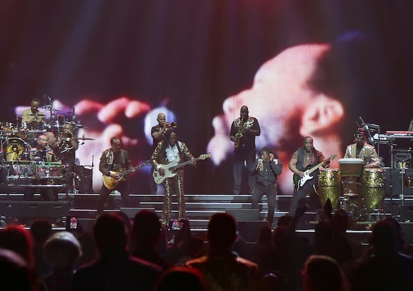 Earth, Wind & Fire perform at State Farm Arena on Sunday, July 19, 2026, in a joint concert with Lionel Richie. The face of deceased founder Maurice White looms in the background. The band kicked off its performance singing hits "Shining Star," "Let Your Feelings Show" and "System of Survival." (Akili-Casundria Ramsess for the AJC)