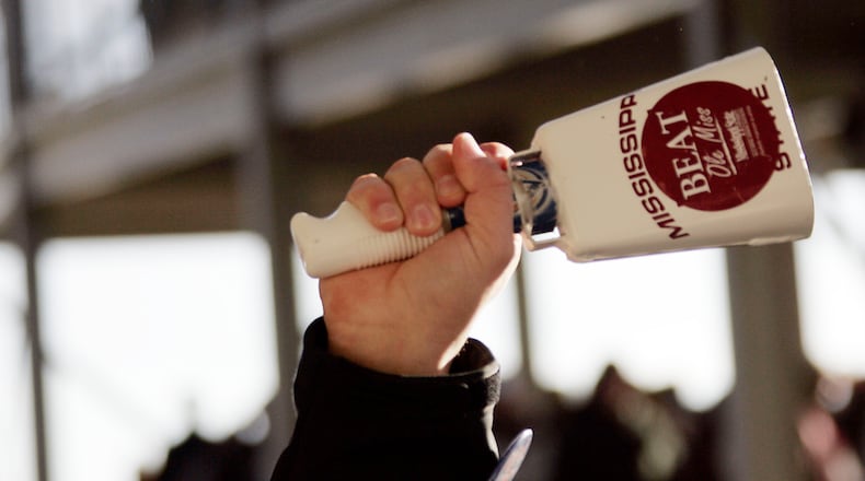 A Mississippi State fan rings a cowbell, a unique part of the experience for teams playing in Starkville. (Rogelio V. Solis/AP)