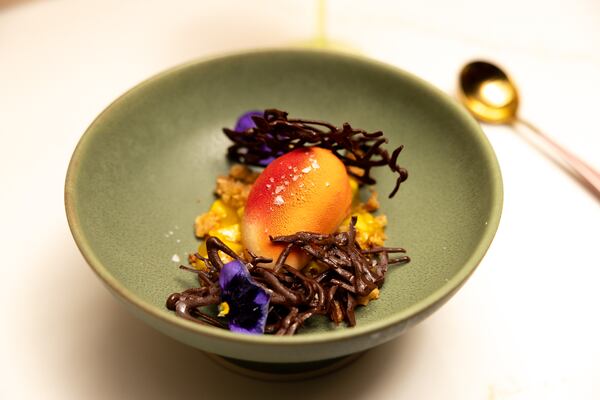 A view of a mini mango, coconut crunch, white chocolate
dessert at Bar Ana in Atlanta on Thursday, December 4, 2025. (Arvin Temkar/AJC)