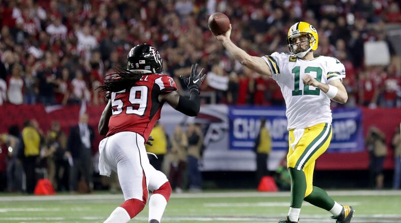 Aaron Rodgers of the Packers looks to pass in the second half against De'Vondre Campbell of the Falcons in the NFC Championship Game at the Georgia Dome on January 22 in Atlanta.