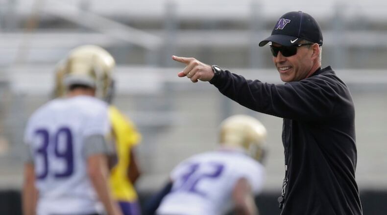 Washington coach Chris Petersen watches college football practice drills in Seattle.