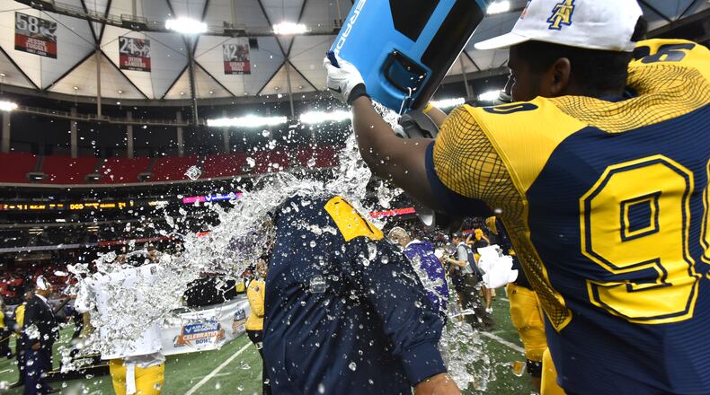 North Carolina A&T head coach Rod Broadway is doused with ice water during North Carolina A&T's 41-34 win over Alcorn State in the 2015 Celebration Bowl at the Georgia Dome on Saturday December 19, 2015. HYOSUB SHIN / HSHIN@AJC.COM