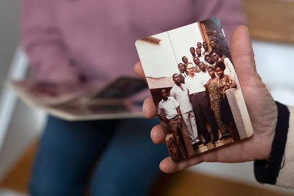 Anna Eisenberg, left, and her mother Cathy Votaw, 69, look at photographs of Votaw's father, Albert Votaw, during his service with USAID in West Africa, Thursday, Feb. 27, 2025, at their home in Washington. (AP Photo/Jacquelyn Martin)