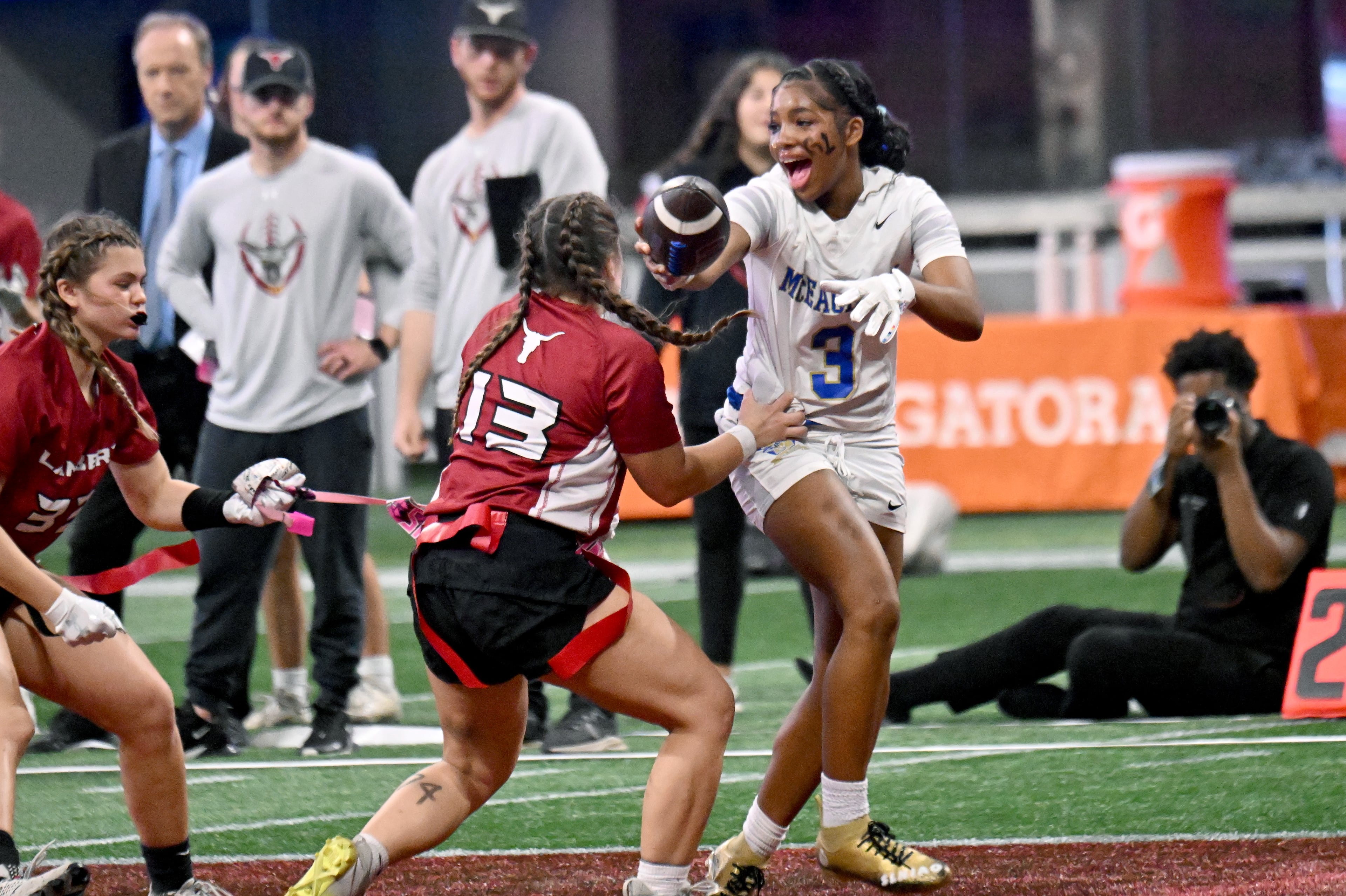 McEachern's Ava Couzens (right) runs for a first down against Lambert's Grayson Moody during the GHSA Division 4 Flag Football State Championship game. McEachern played 32 games this summer and practiced three times per week with weight training and conditioning. (Hyosub Shin/AJC 2024)