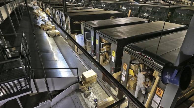 UPS trucks are loaded at the Roswell UPS package distribution center in 2014. JOHN SPINK / JSPINK@AJC.COM