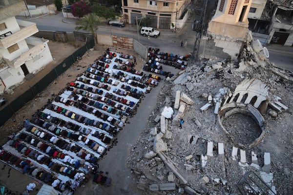 Palestinians offer Eid al-Adha prayers beside the ruins of a mosque destroyed by Israeli bombardment, in Deir al-Balah, Gaza on Friday, June 6, 2025. (AP Photo/Abdel Kareem Hana)