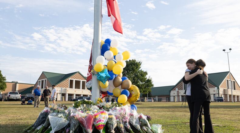 Students embrace near a makeshift memorial at Apalachee High School on Sept. 5, 2024, in Winder, Georgia. (Jessica McGowan/Getty Images/TNS)