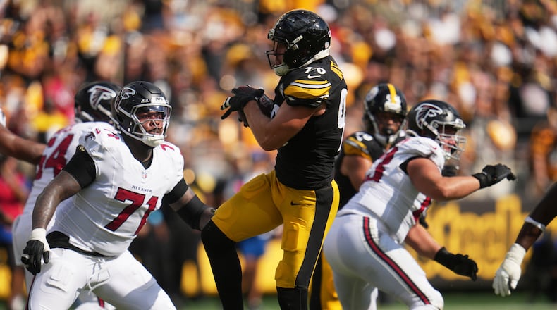 Pittsburgh Steelers outside linebacker T.J. Watt (center) intercepts a pass made by Atlanta Falcons quarterback Cooper Rush (right) during an NFL football game, Sunday, Sept. 13, 2026, in Pittsburgh. (Gene J. Puskar/AP)