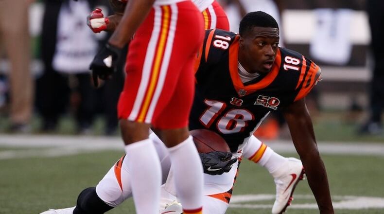 Cincinnati Bengals wide receiver A.J. Green (18) loses his helmet after making a reception in the first half of an NFL preseason football game against the Kansas City Chiefs, Saturday, Aug. 19, 2017, in Cincinnati. (AP Photo/Gary Landers)
