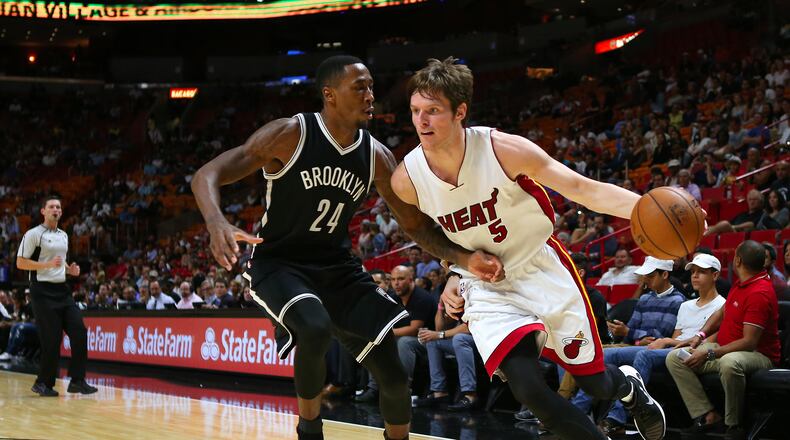 The Miami Heat's Luke Babbitt, right, drives against the Brooklyn Nets' Rondae Hollis-Jefferson in the fourth quarter of preseason action at American Airlines Arena in Miami on Tuesday, Oct. 11, 2016. The Heat won, 121-100. (David Santiago/El Nuevo Herald/TNS)