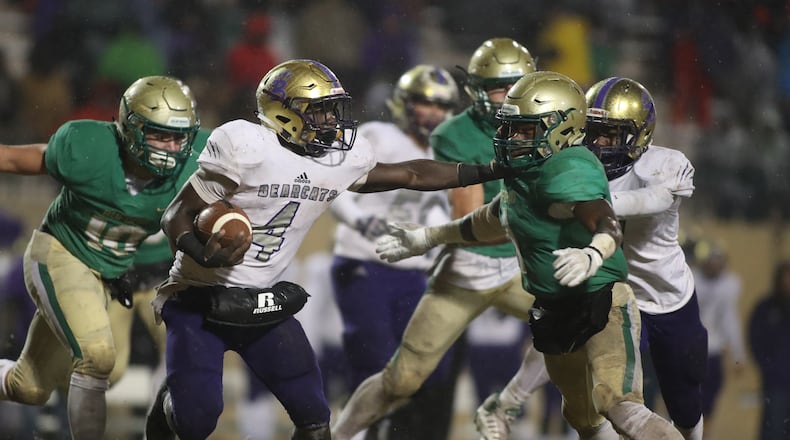 November 23, 2018 - Buford, Ga: Bainbridge running back Rashad Broadax (4) stiff arms Buford defensive back Jamaal Singleton (1) on a run in the second half at Buford High School Friday, November 23, 2018, in Buford, Ga. Buford lost to Bainbridge 23-20. This is the quarter finals of the Class 5A state playoffs. (JASON GETZ/SPECIAL TO THE AJC)