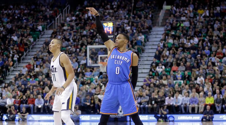 Oklahoma City Thunder guard Russell Westbrook (0) follows through with his shot as Utah Jazz guard Dante Exum (11) looks on in the second quarter during an NBA basketball game Wednesday, Dec. 14, 2016, in Salt Lake City. (AP Photo/Rick Bowmer)