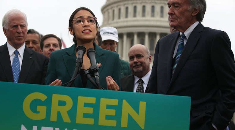 Rep. Alexandria Ocasio-Cortez (D-N.Y.) speaks as Sen. Ed Markey (D-Mass.), right, and other Congressional Democrats listen during a news conference in front of the U.S. Capitol on Thursday, Feb. 7, 2019, in Washington, DC. **FOR USE WITH THIS STORY ONLY**(Alex Wong/Getty Images/TNS)