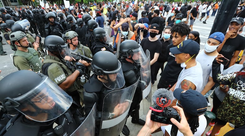 053120 Atlanta: Riot police and protesters face off outside the CNN Center at Olympic Park during the third day of protests over the death of George Floyd on Sunday, May 31, 2020, in Atlanta. Curtis Compton ccompton@ajc.com