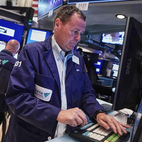 Trader Matthew Cheslock, right, works on the floor of the New York Stock Exchange, Tuesday, June 16, 2026. (AP Photo/Richard Drew)