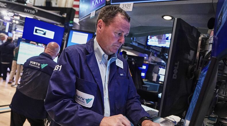 Trader Matthew Cheslock, right, works on the floor of the New York Stock Exchange, Tuesday, June 16, 2026. (AP Photo/Richard Drew)