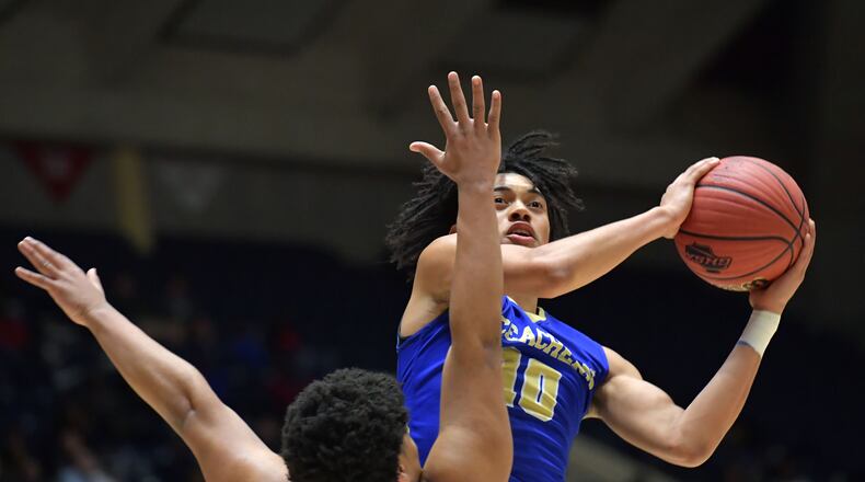March 9, 2019 Macon - McEachern Alyn Breed (10) prepares to shoot against Meadowcreek Kedric Green (2) in GHSA State Basketball Championship game at the Macon Centreplex in Macon on Saturday, March 9, 2019. McEachern won 62-54 over the Meadowcreek. HYOSUB SHIN / HSHIN@AJC.COM