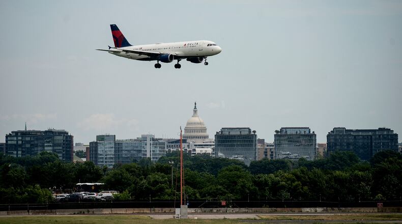 A Delta Air Lines flight, with the U.S. Capitol in the background, approaches to land at Ronald Reagan Washington National Airport in Arlington, Virginia, on July 2, 2022. (Stefani Reynolds/AFP/Getty Images/TNS)