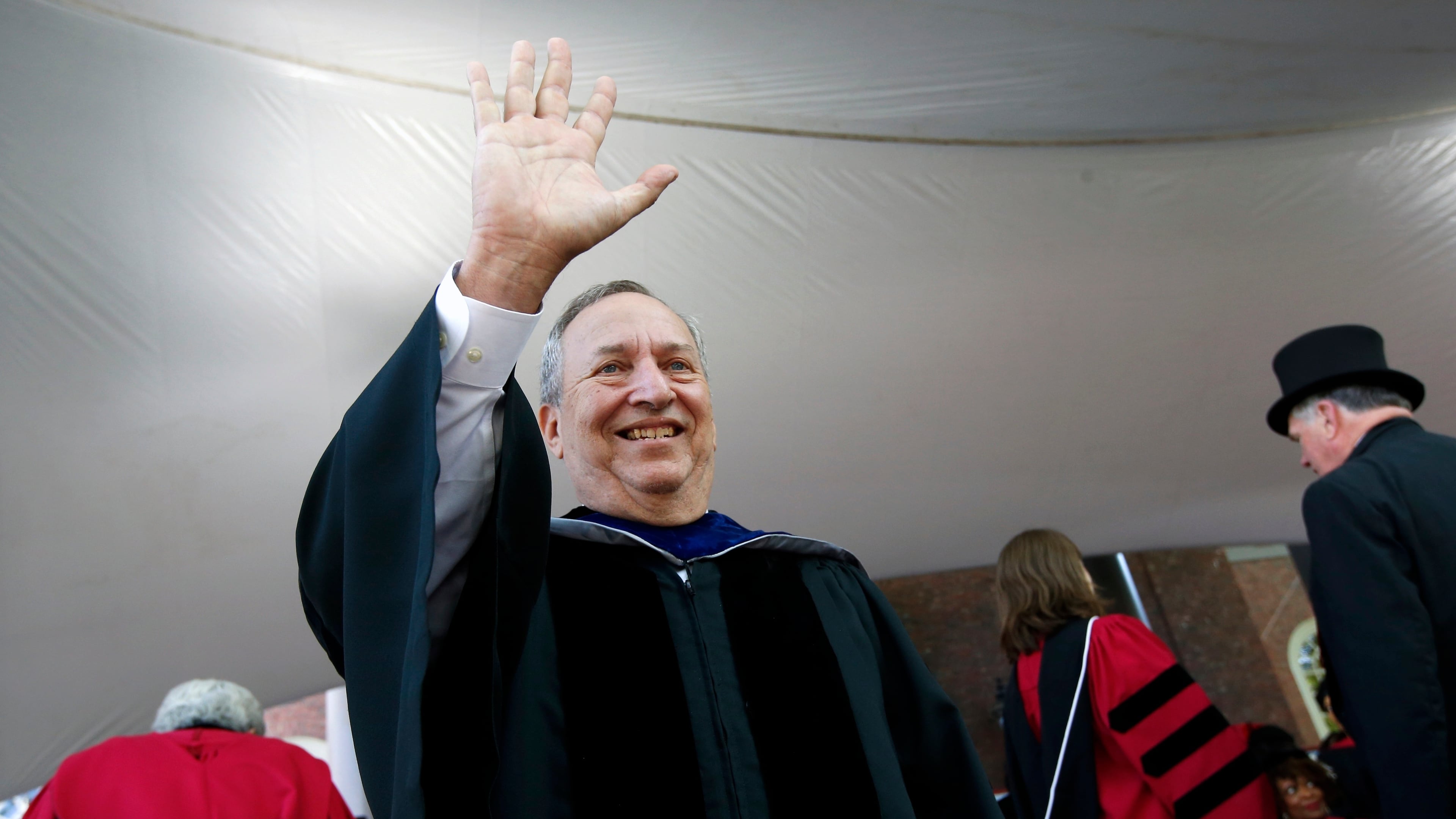 FILE -Former Harvard University president Larry Summers waves during Harvard commencement exercises, May 24, 2018, in Cambridge, Mass. (AP Photo/Michael Dwyer, File)