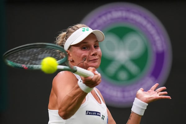 Dayana Yastremska of Ukraine returns the ball to Coco Gauff of the U.S. during their first round women's single match at the Wimbledon Tennis Championships in London, Tuesday, July 1, 2025.(AP Photo/Kirsty Wigglesworth)