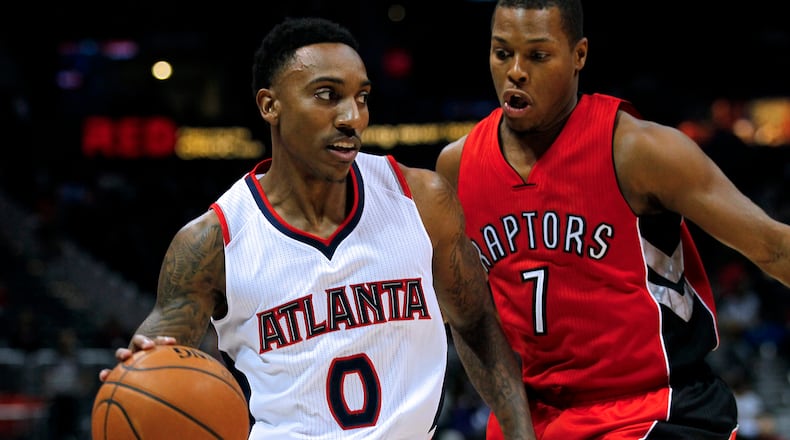Atlanta Hawks guard Jeff Teague (0) drives to the basket around Toronto Raptors guard Kyle Lowry (7) in the first period in an NBA basketball game in Atlanta, Wednesday, Nov. 26, 2014. (AP Photo/Todd Kirkland)