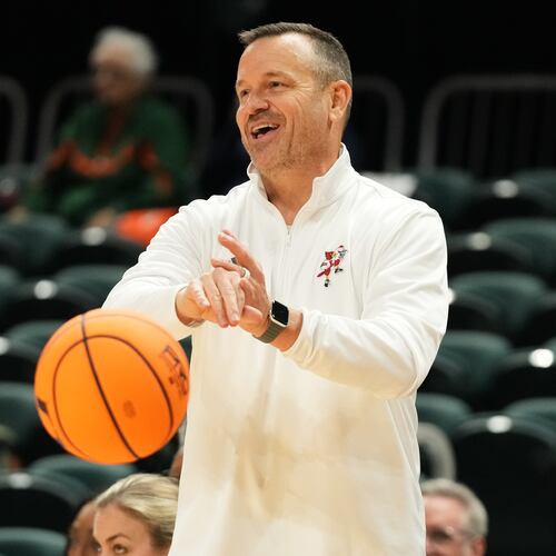 Louisville head coach Jeff Walz puts the ball back into play during the second half of an NCAA college basketball game against Miami, Thursday, Jan. 8, 2026, in Coral Gables, Fla. (AP Photo/Lynne Sladky)