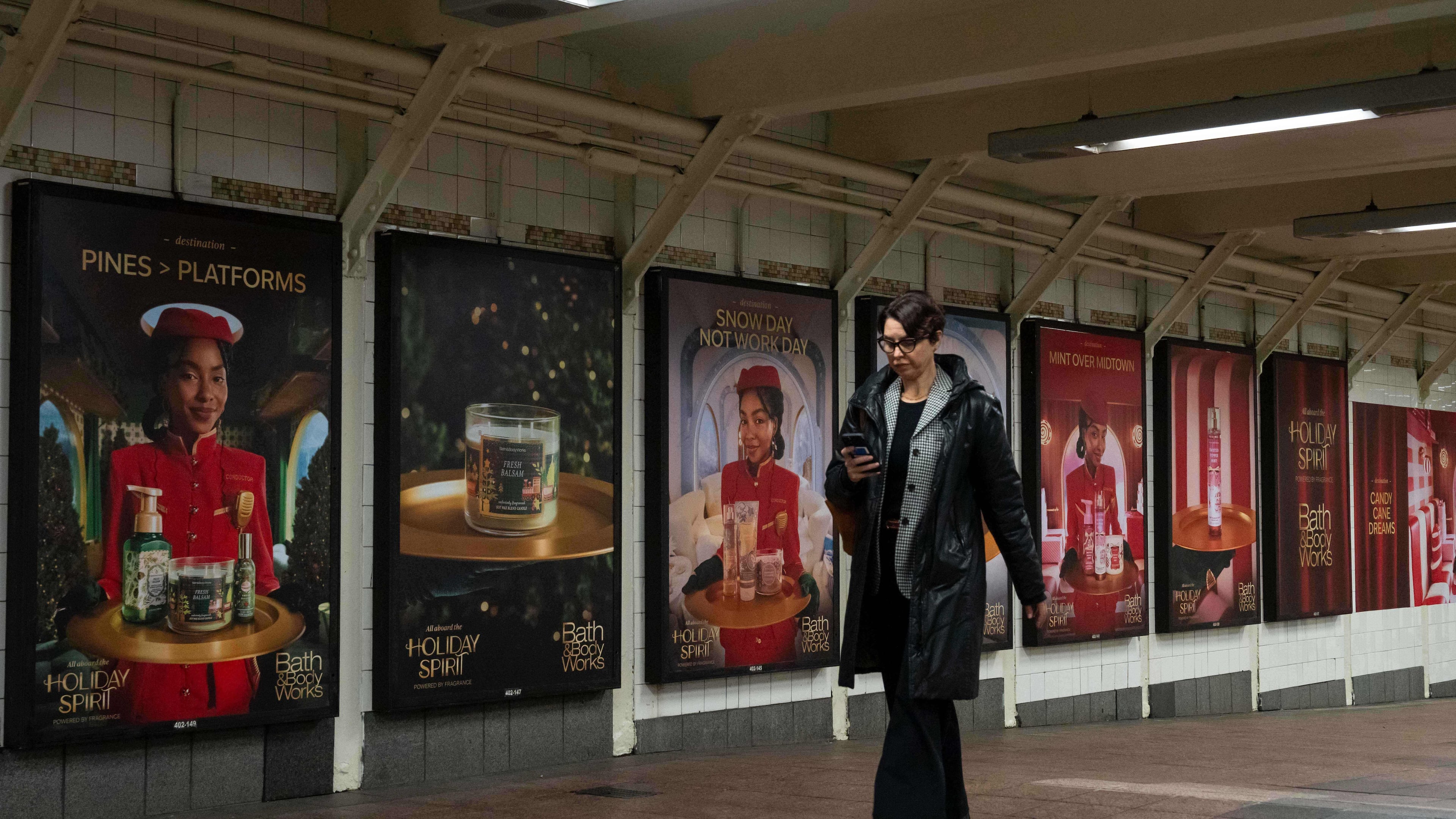 A person walks past posters promoting the campaign by Bath & Body Works at Grand Central station, Wednesday, Nov. 19, 2025, in New York. (AP Photo/Yuki Iwamura)