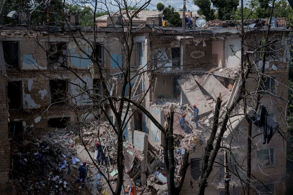 Rescue workers clear the rubble of a residential house destroyed by a Russian strike in Kyiv, Ukraine, on Monday, June 23, 2025. (AP Photo/Evgeniy Maloletka)
