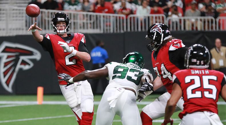 Falcons quarterback Matt Ryan dumps off a pass to running back Ito Smith under pressure from New York Jets linebacker Tarell Basham.   Curtis Compton/ccompton@ajc.com