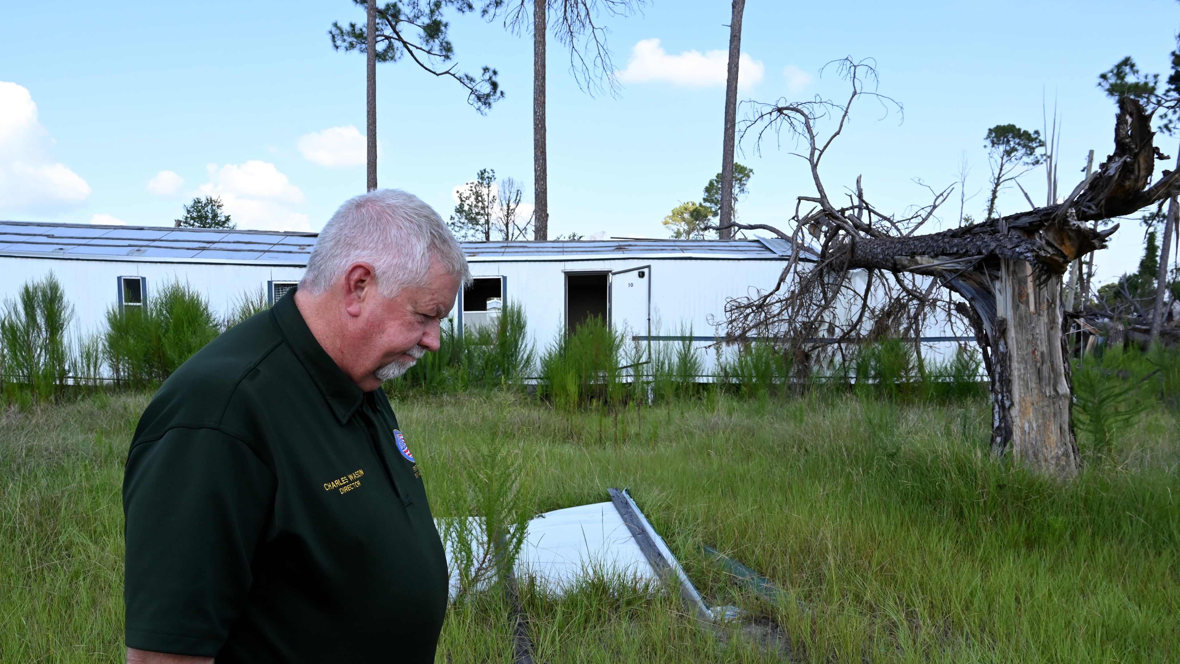 Charles Wasdin, Jeff Davis County's fire chief and director of emergency management, pauses as he shows a destroyed mobile home community in Hazlehurst on Thursday, Aug. 21, 2025, almost a year after Hurricane Helene. (Hyosub Shin/AJC)