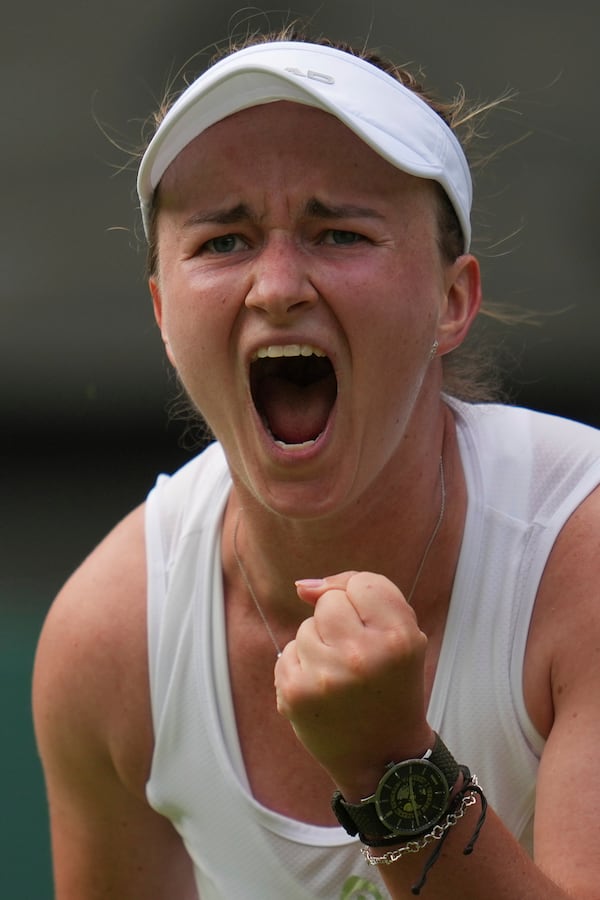 Barbora Krejcikova of Czech Republic celebrates after beating Alexandra Eala of the Philippines in their first round women's singles match at the Wimbledon Tennis Championships in London, Tuesday, July 1, 2025. (AP Photo/Kin Cheung)